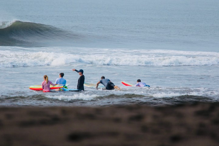 a group of people sitting at a beach