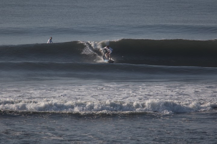 a man riding a wave on a surfboard in the ocean