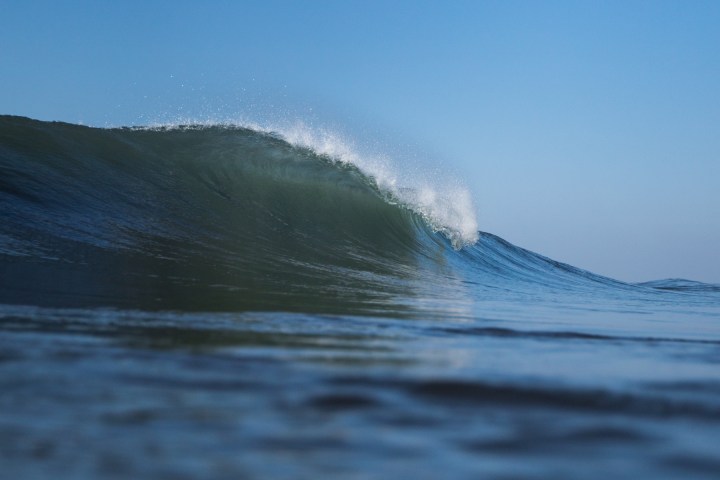 a man riding a wave on a surfboard in the water