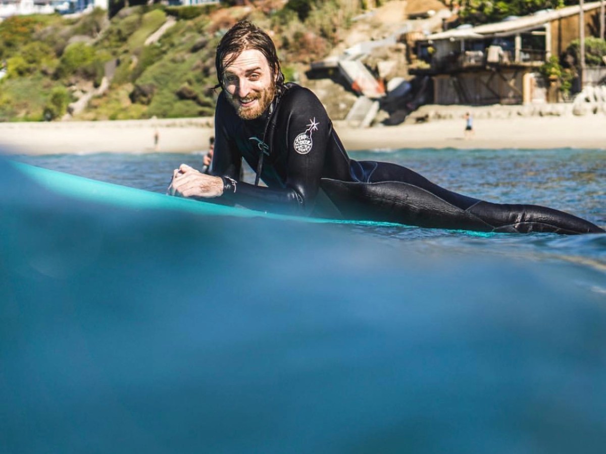 a person riding a surf board on a body of water