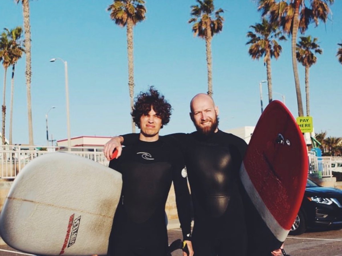 a man carrying a surf board